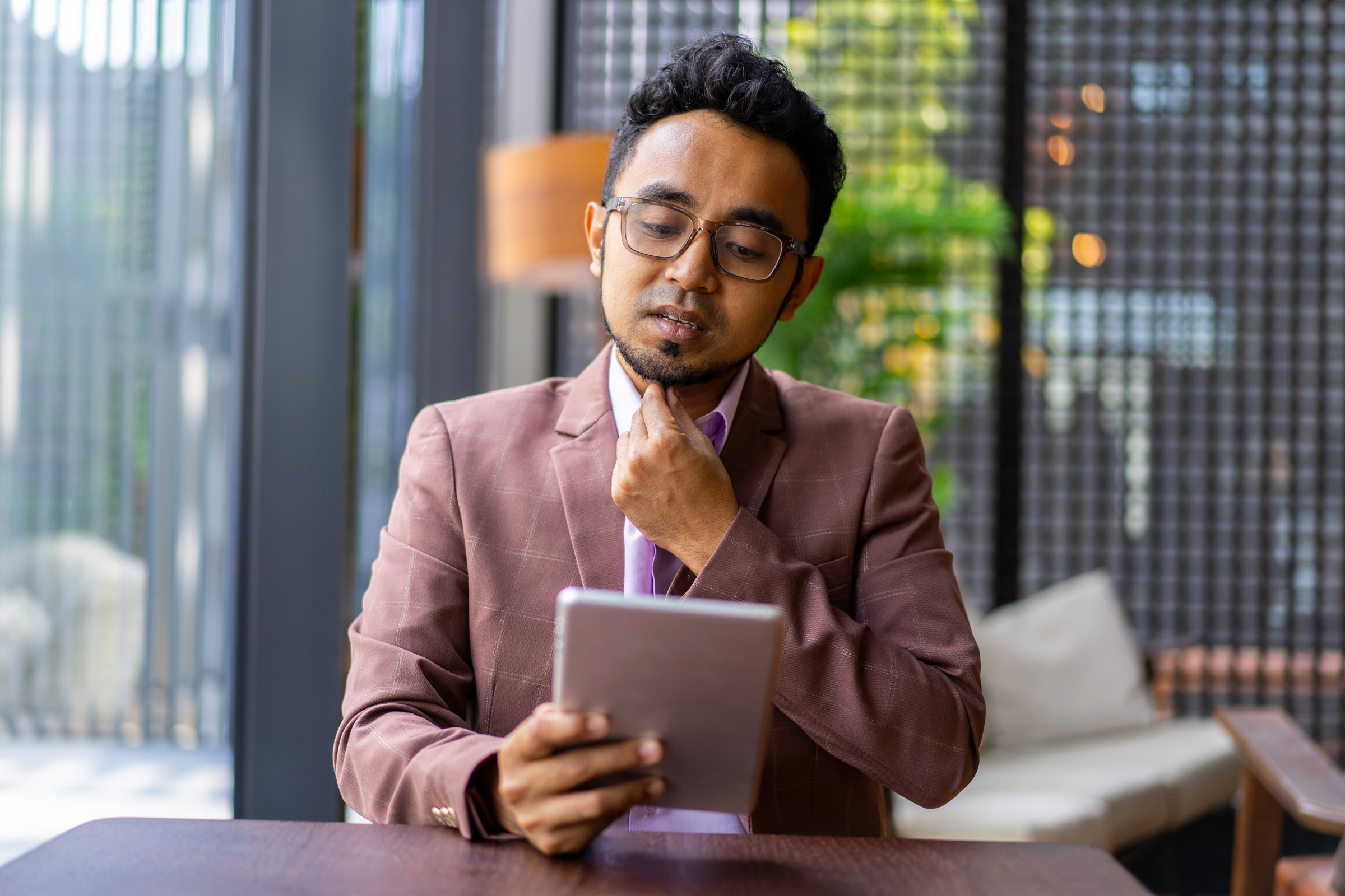 Asian Malay businessman preparing for a video interview online.